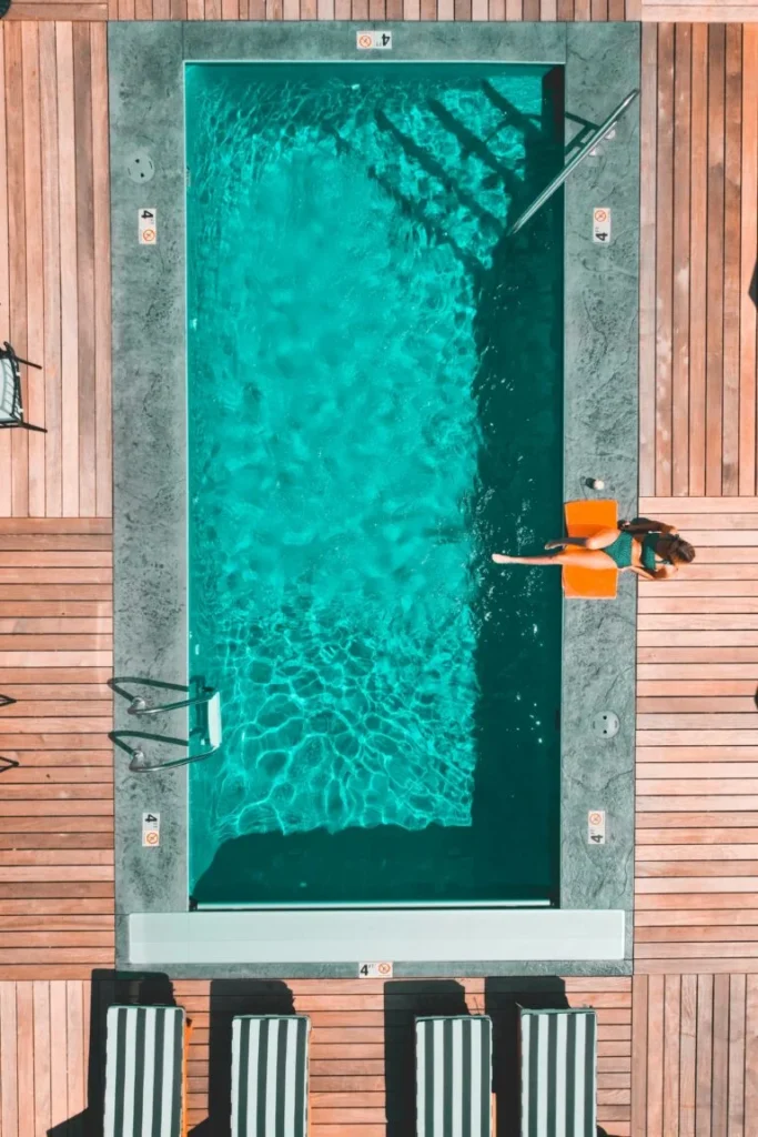 Aerial View Of A Pool Surrounded By Wooden Decking